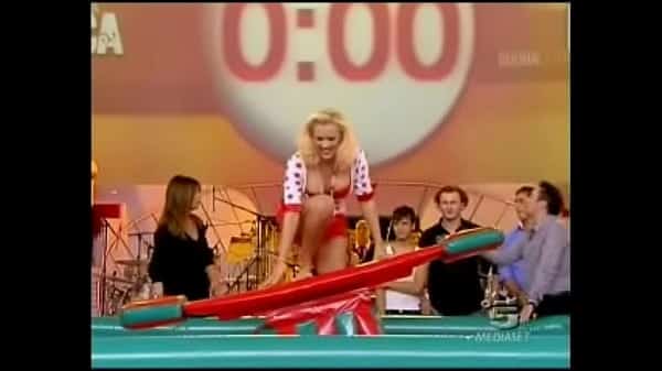 Italian celeb in miniskirt gets caught in a rare upskirt moment while surfing indoors for a show.